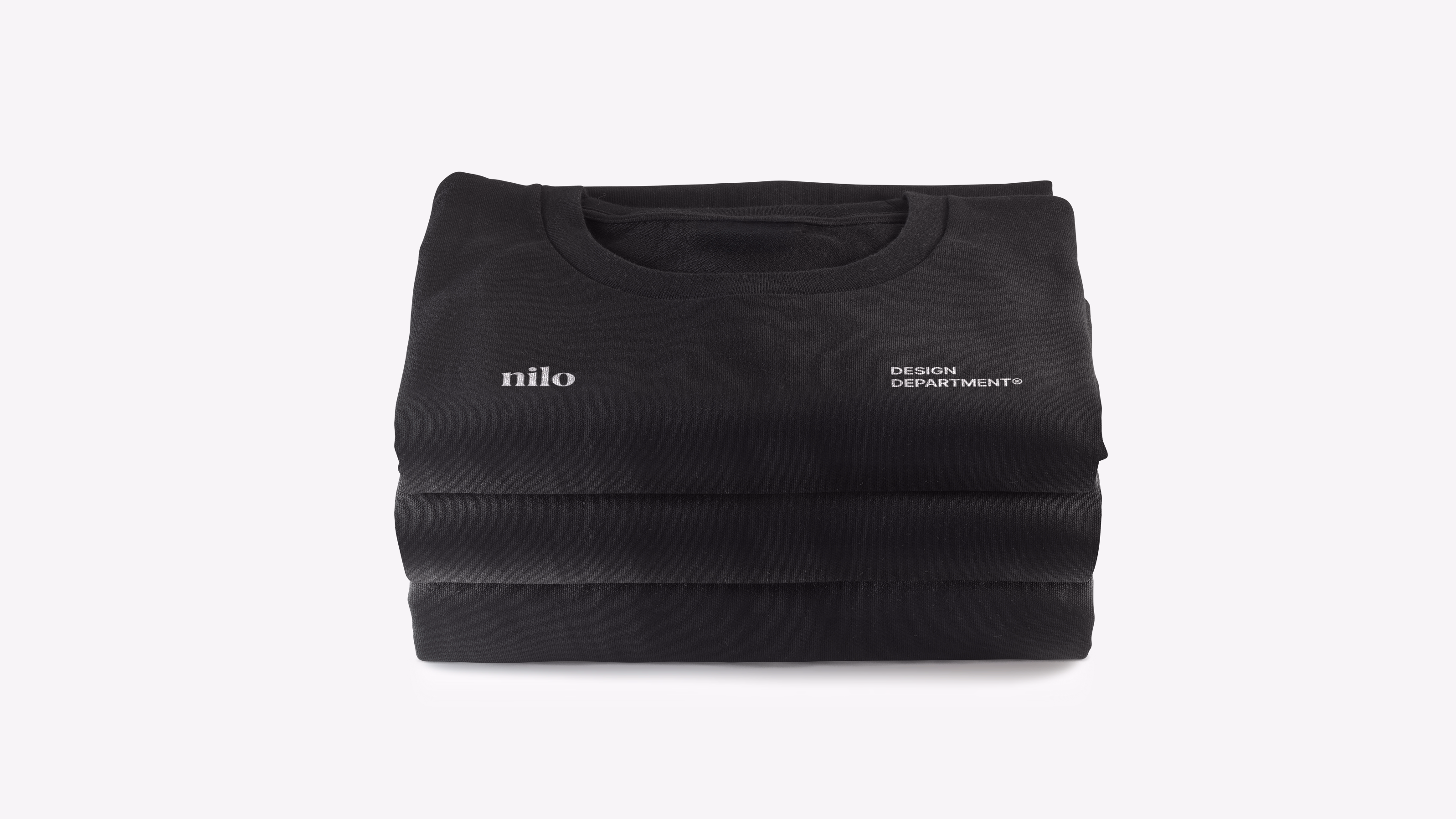 Nilo — Stacked black t-shirts with logo and Design Department