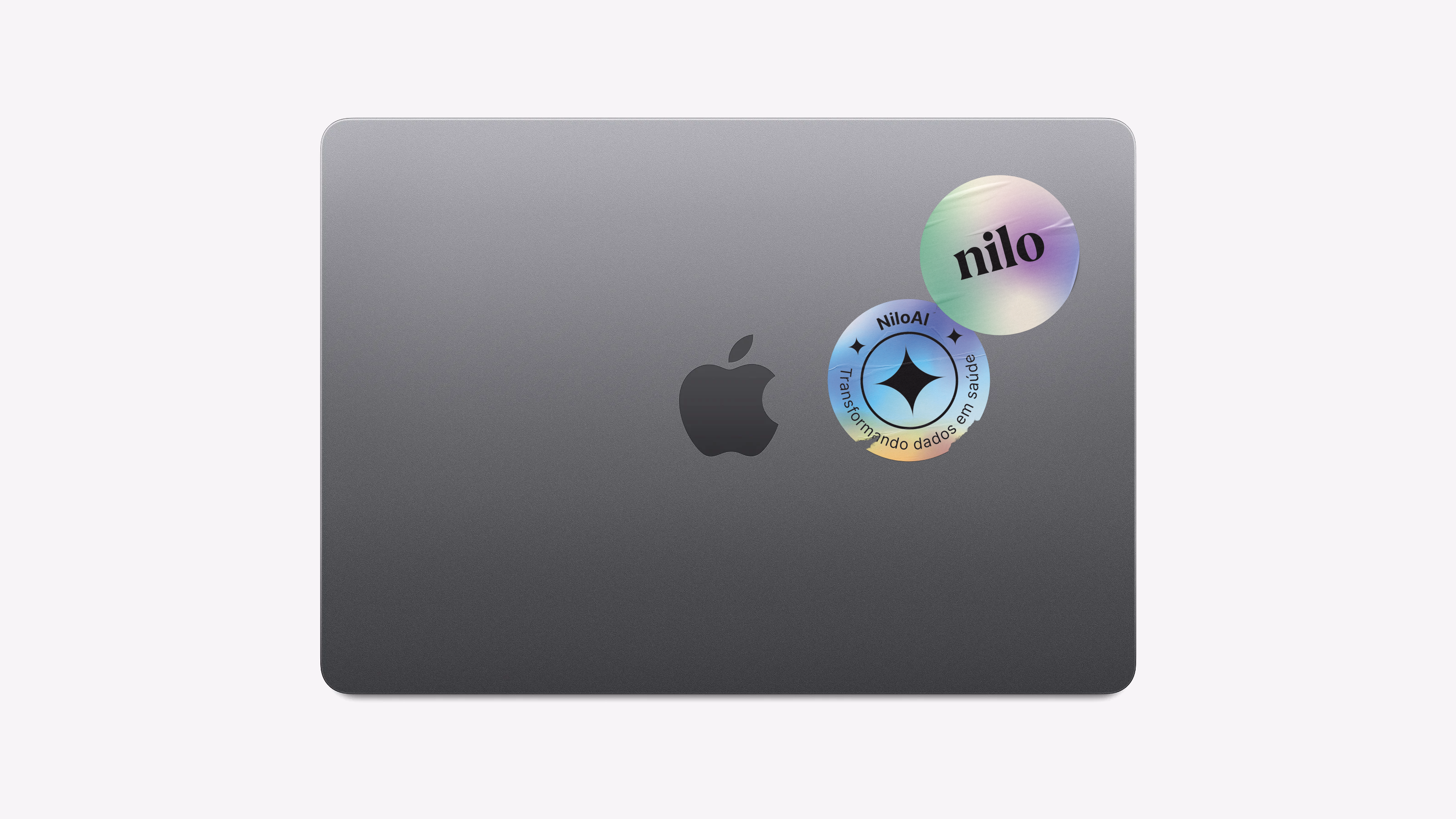 Nilo — MacBook mockup with holographic Nilo and NiloAI stickers